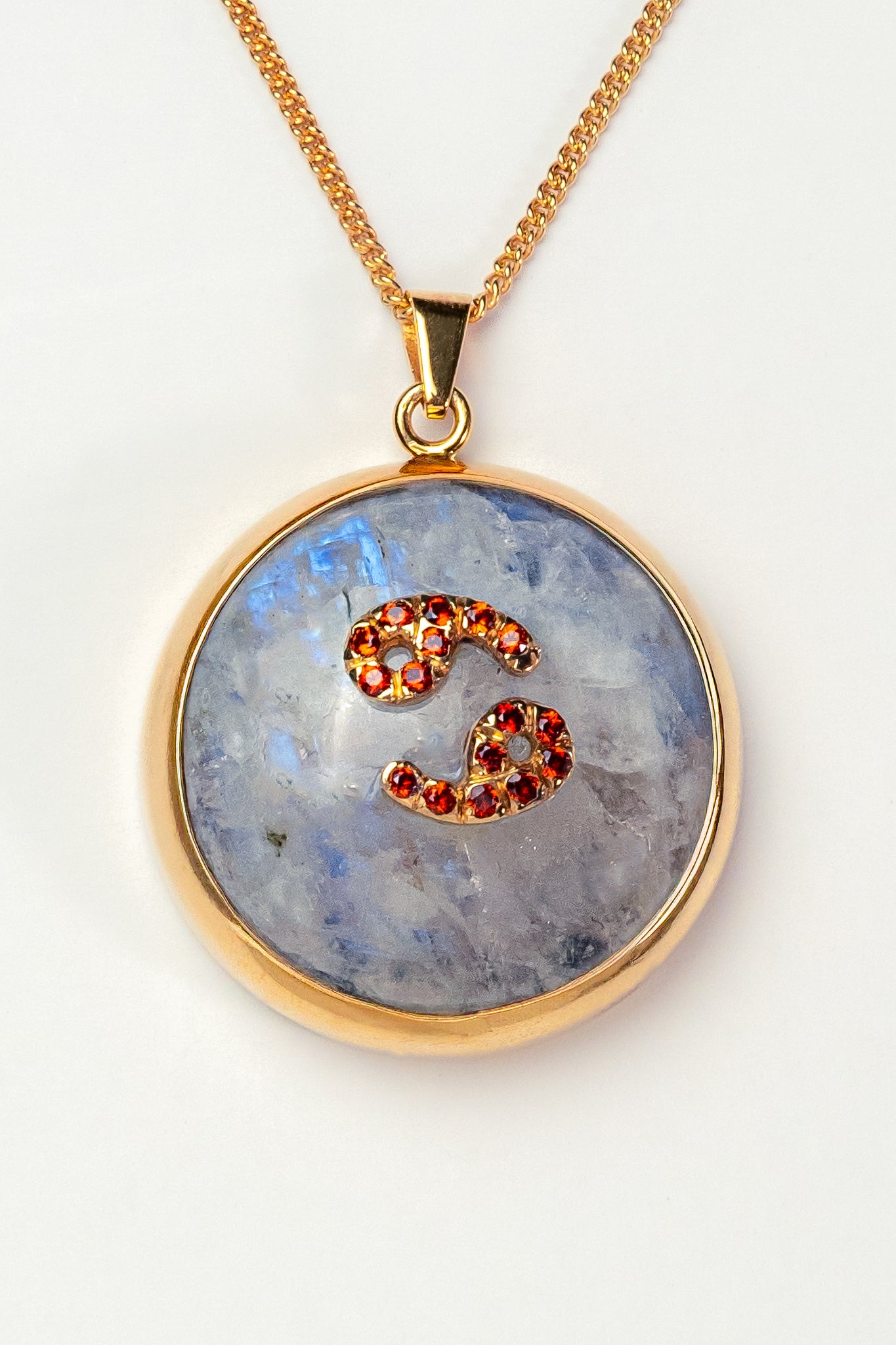 Cancer zodiac pendant: moonstone cabochon and red garnets.

Amuleto de Cáncer: piedra luna cabujón y granates rojos.