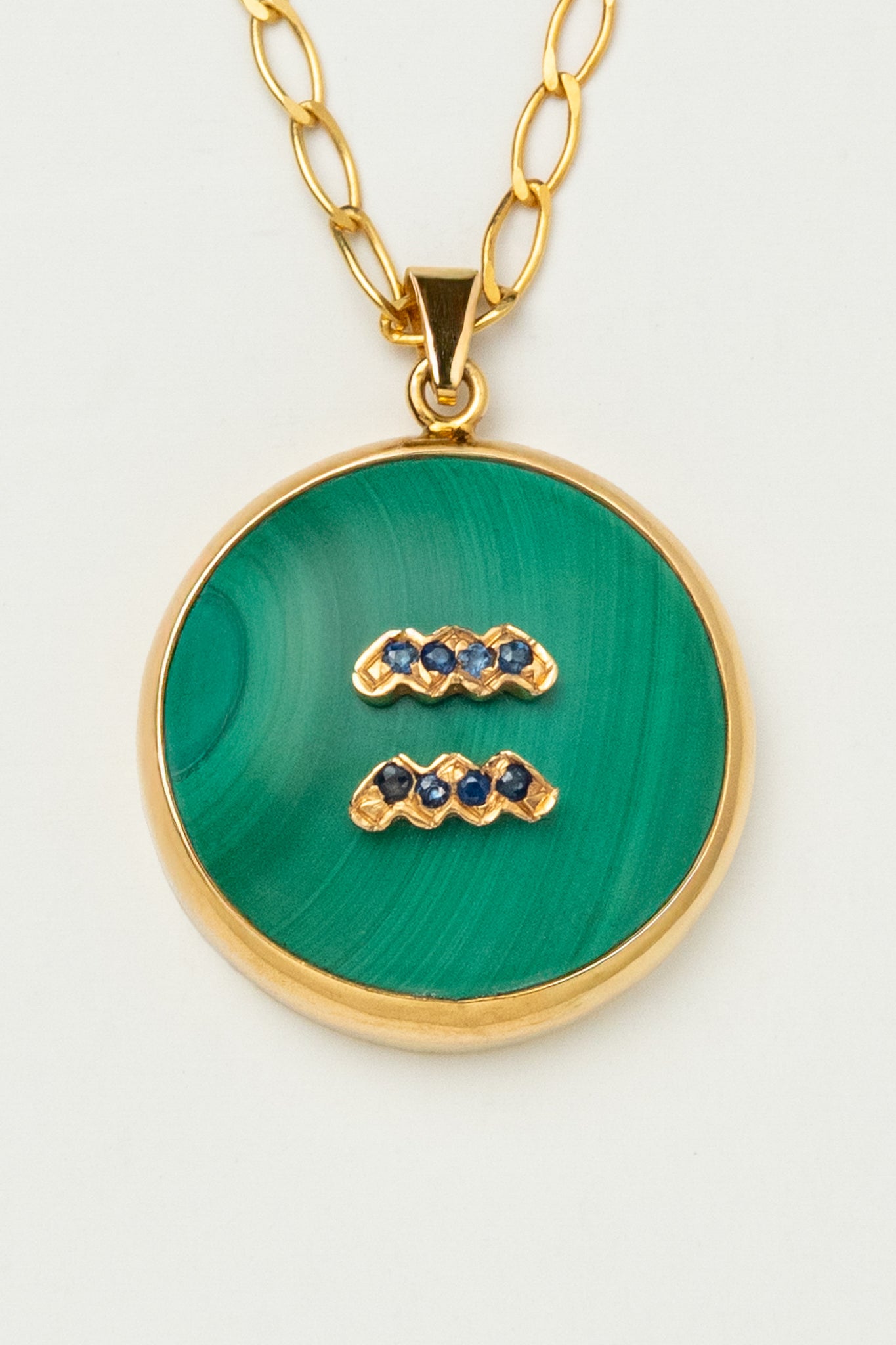 Aquarius zodiac pendant: malachite cabochon and blue sapphire.

Amuleto de Acuario: malaquita cabujón y zafiro azul.